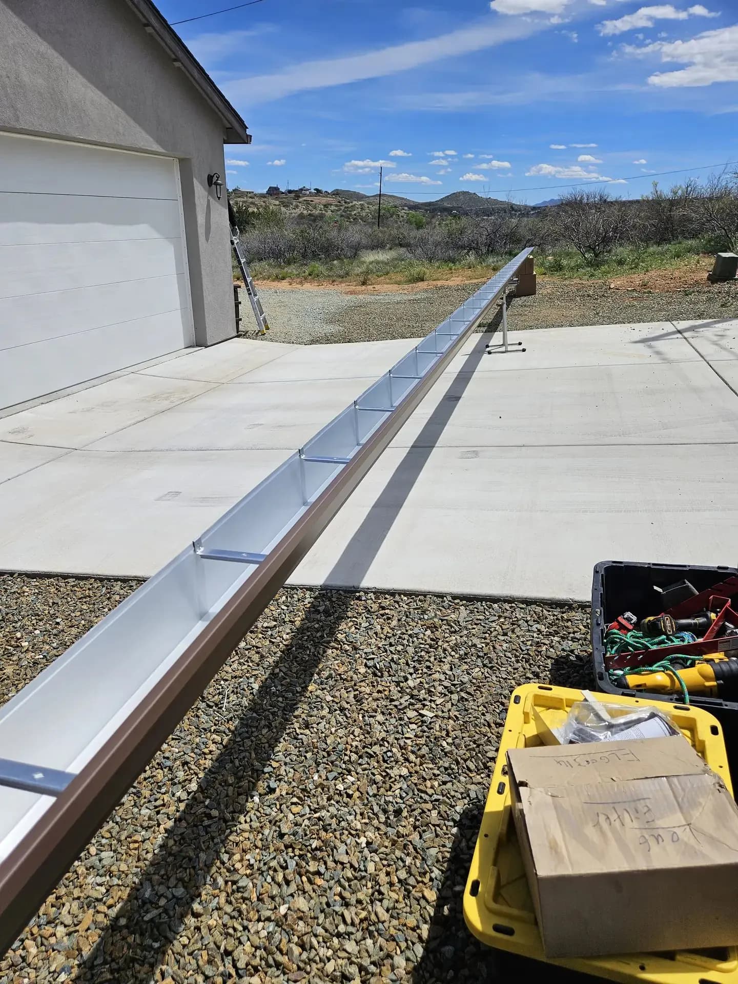 Long seamless gutter run going up on a garage