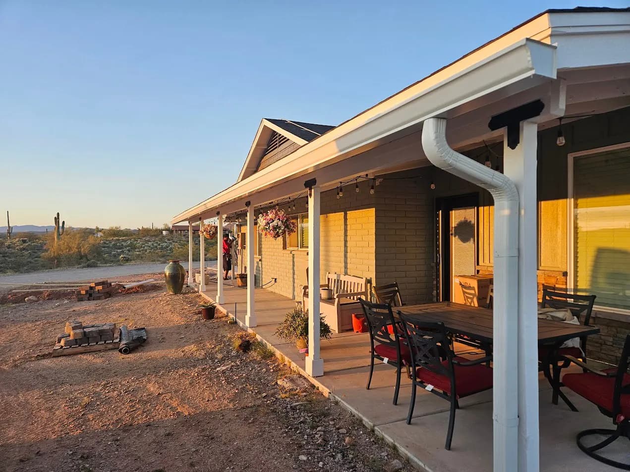 White seamless gutters and downspout on a covered back porch